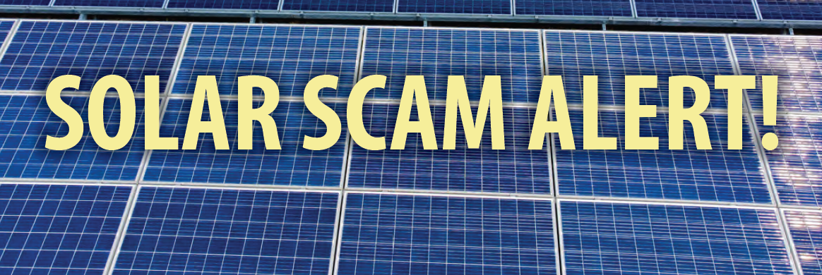 Solar array with the words "Solar Scam Alert!" in front of it