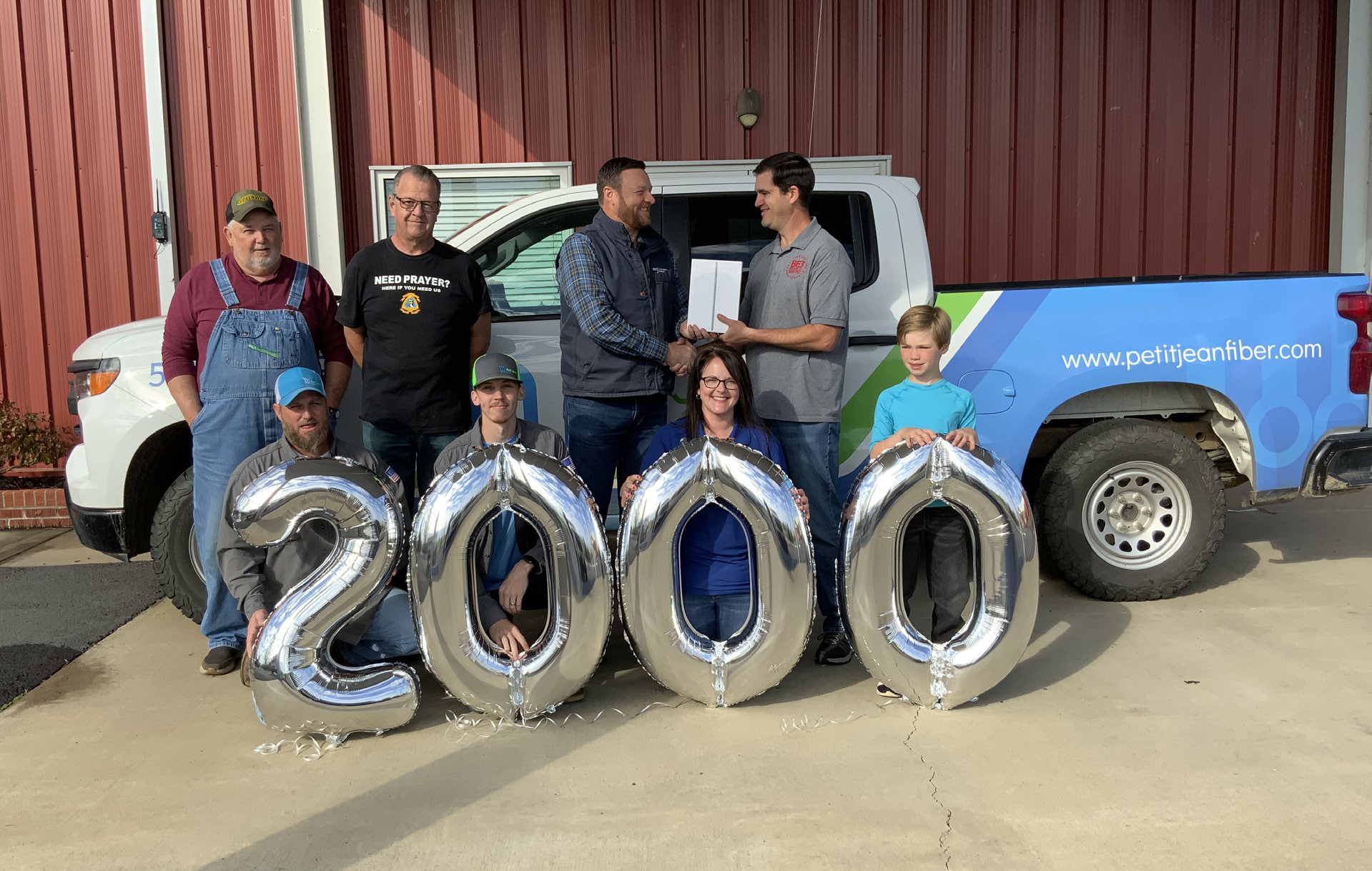 Image of people standing in front of a "2000" balloon